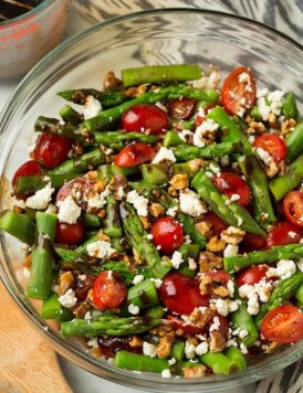 An asparagus and feta salad in a glass bowl