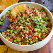 Avocado salsa shown with tortilla chips for dipping.