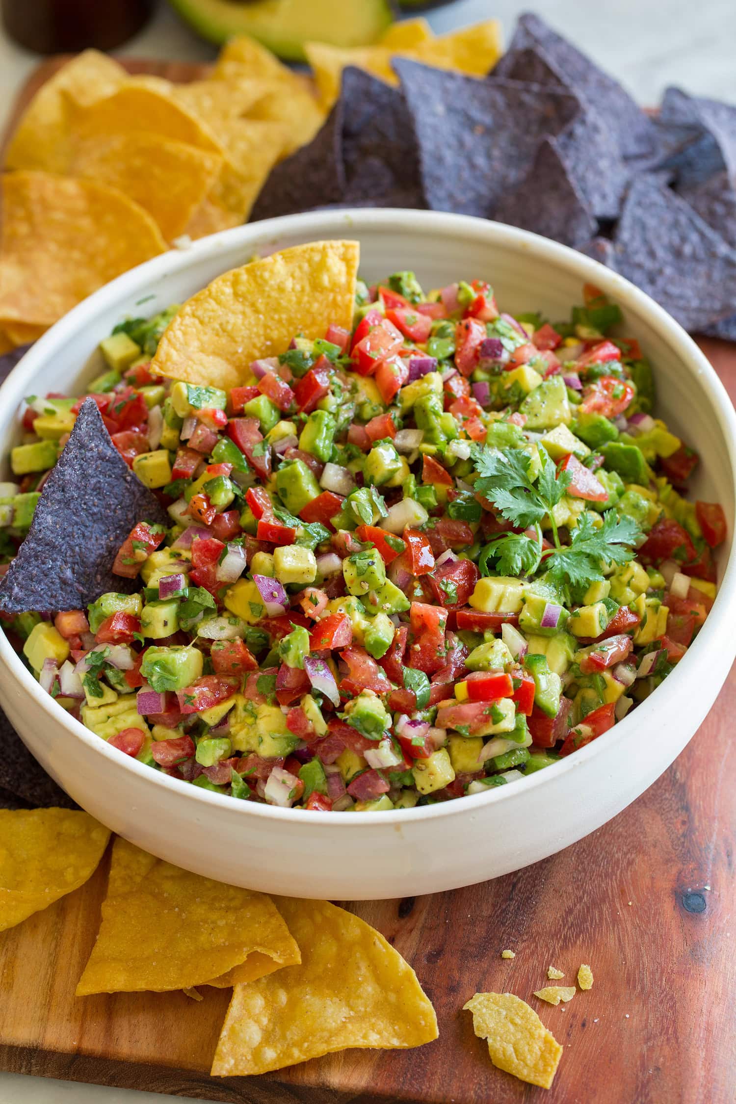 Avocado salsa shown with tortilla chips for dipping.