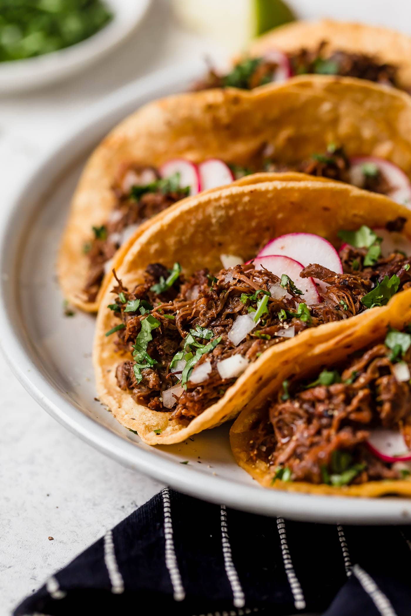 Barbacoa beef layered into tacos