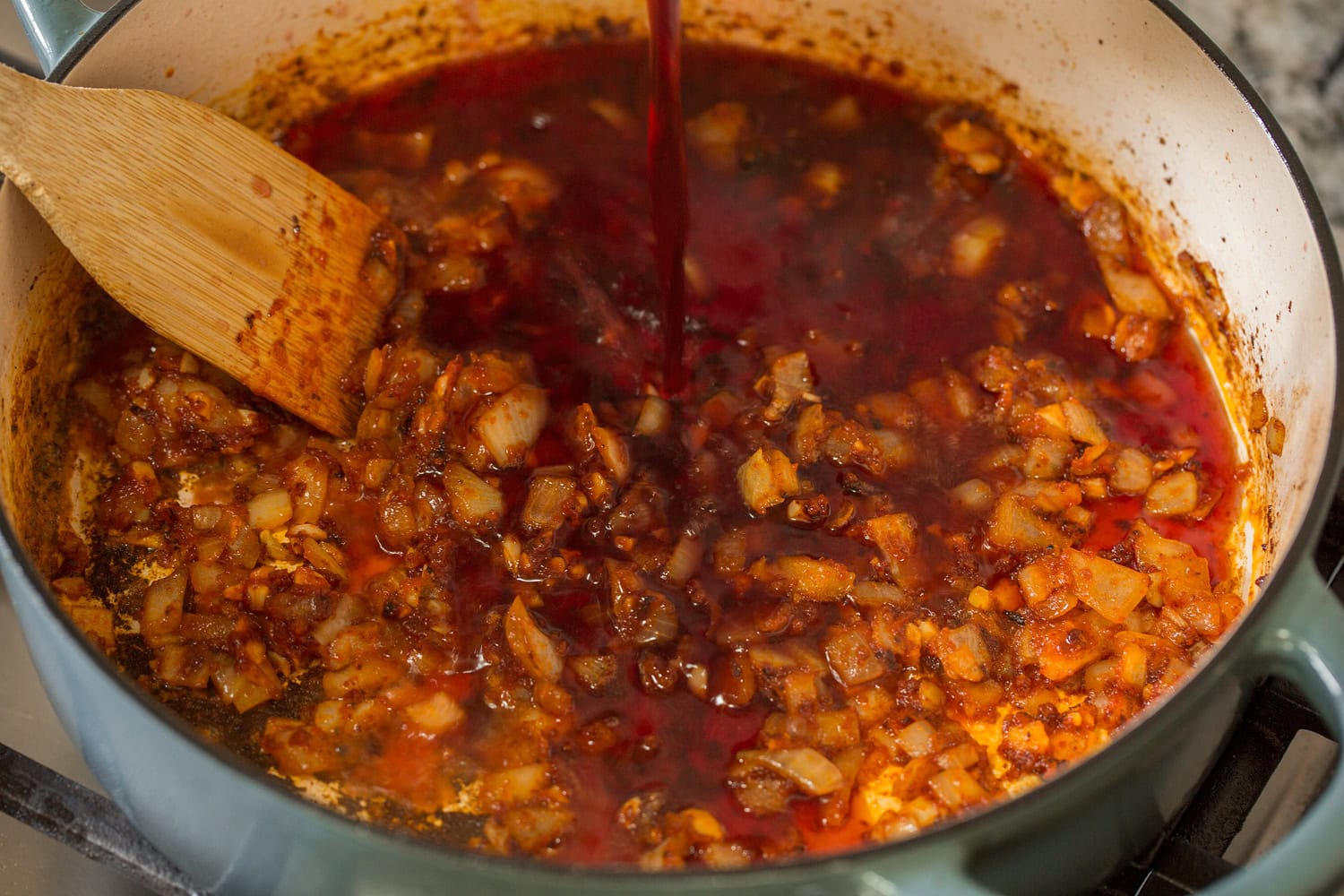 Red wine poured into pan.