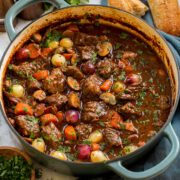 Beef bourguignon in a blue wide braiser pot.