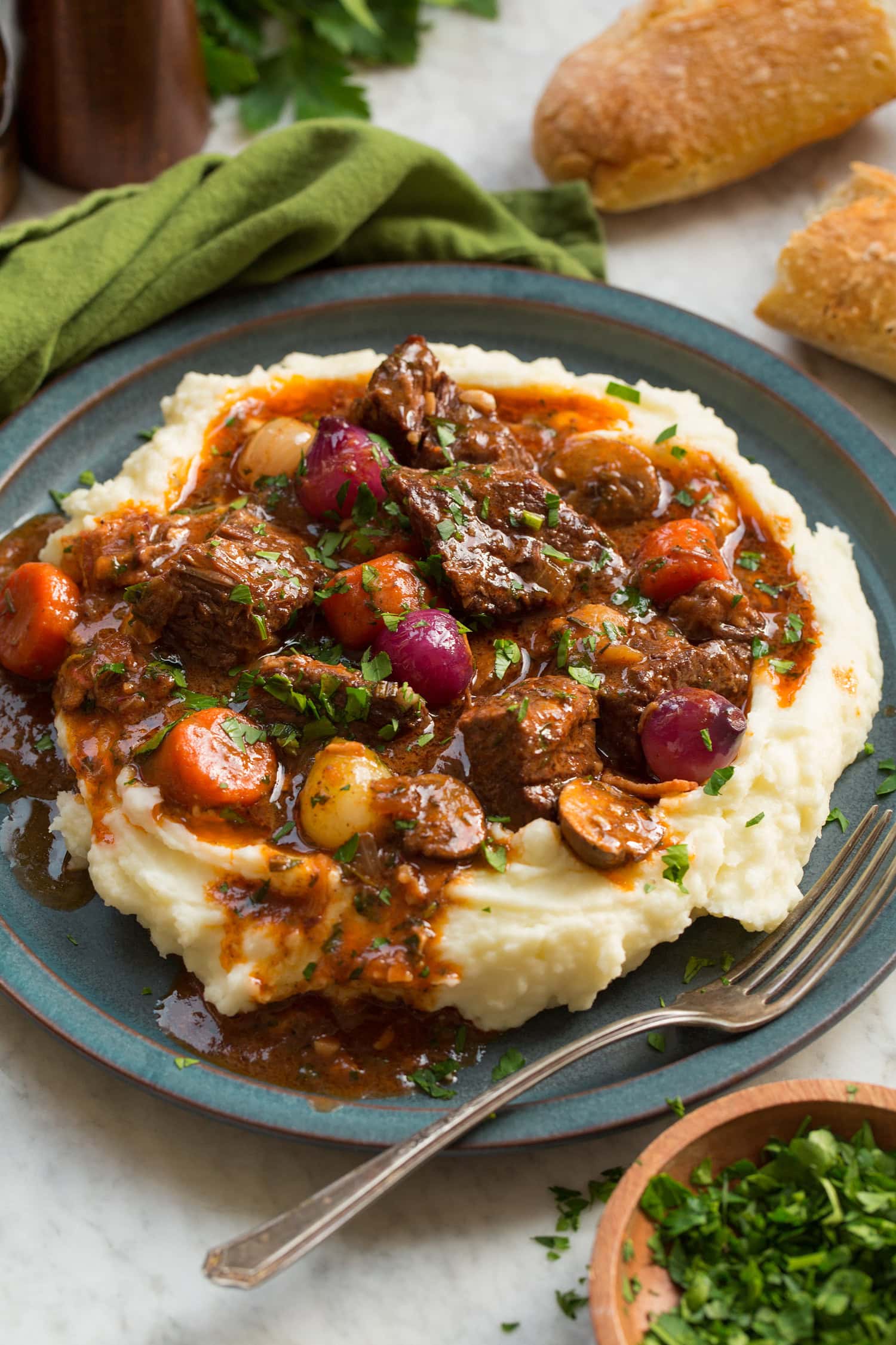 Beef bourguignon served over mashed potatoes.