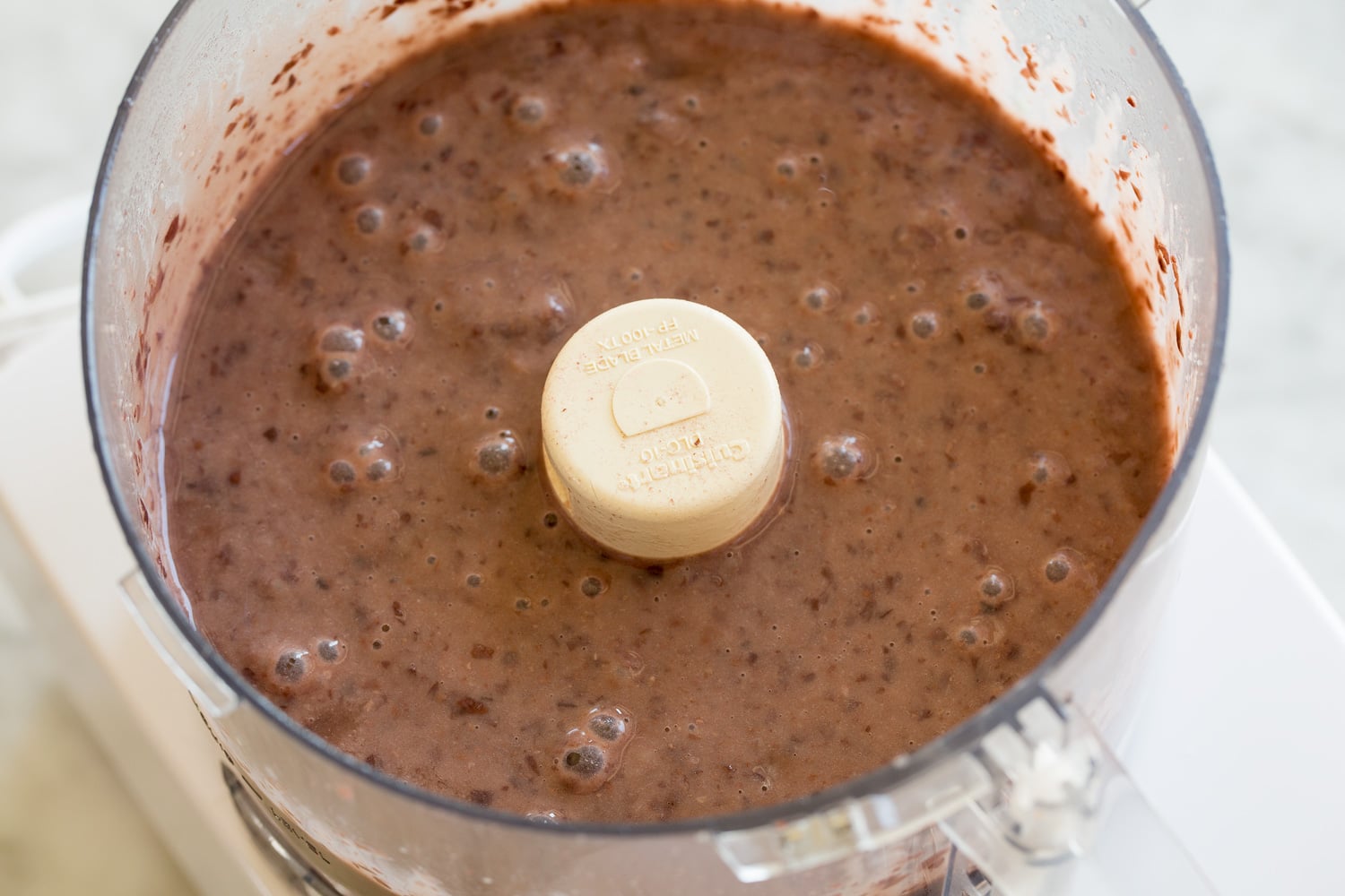 Pureed black beans in a food processor. 