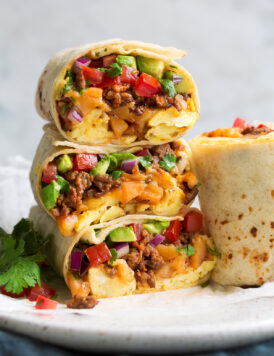 Stack of breakfast burritos.