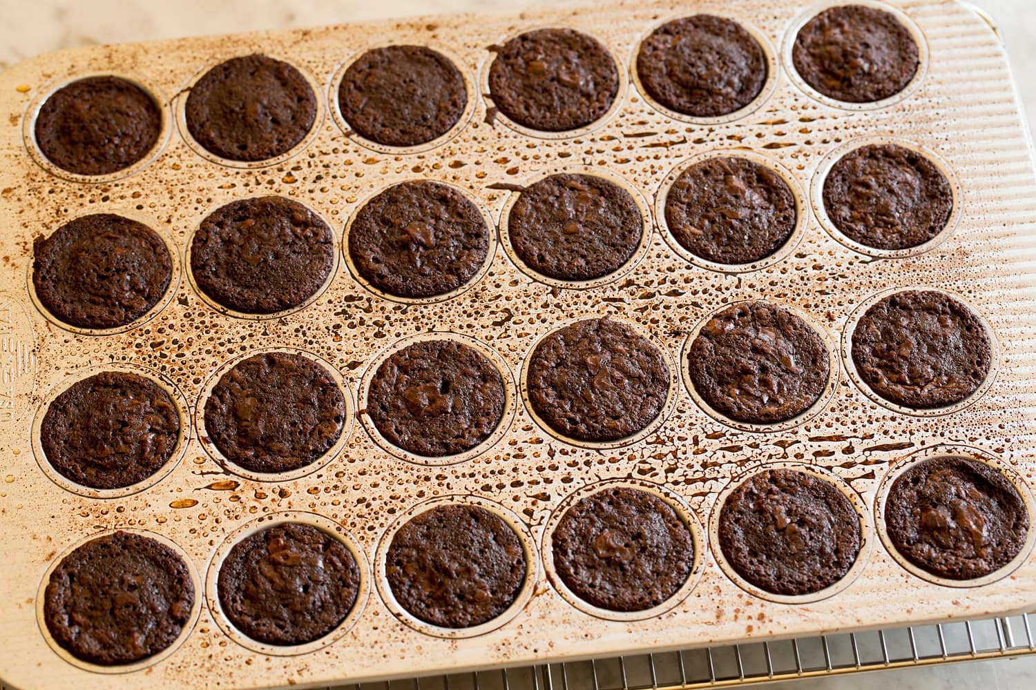 Brownie bites shown in baking pan after finished baking.