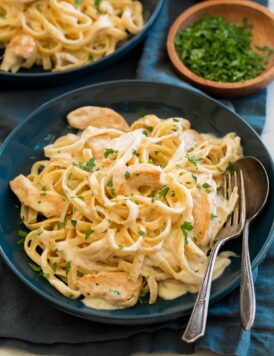 Chicken alfredo in a blue pasta bowl.