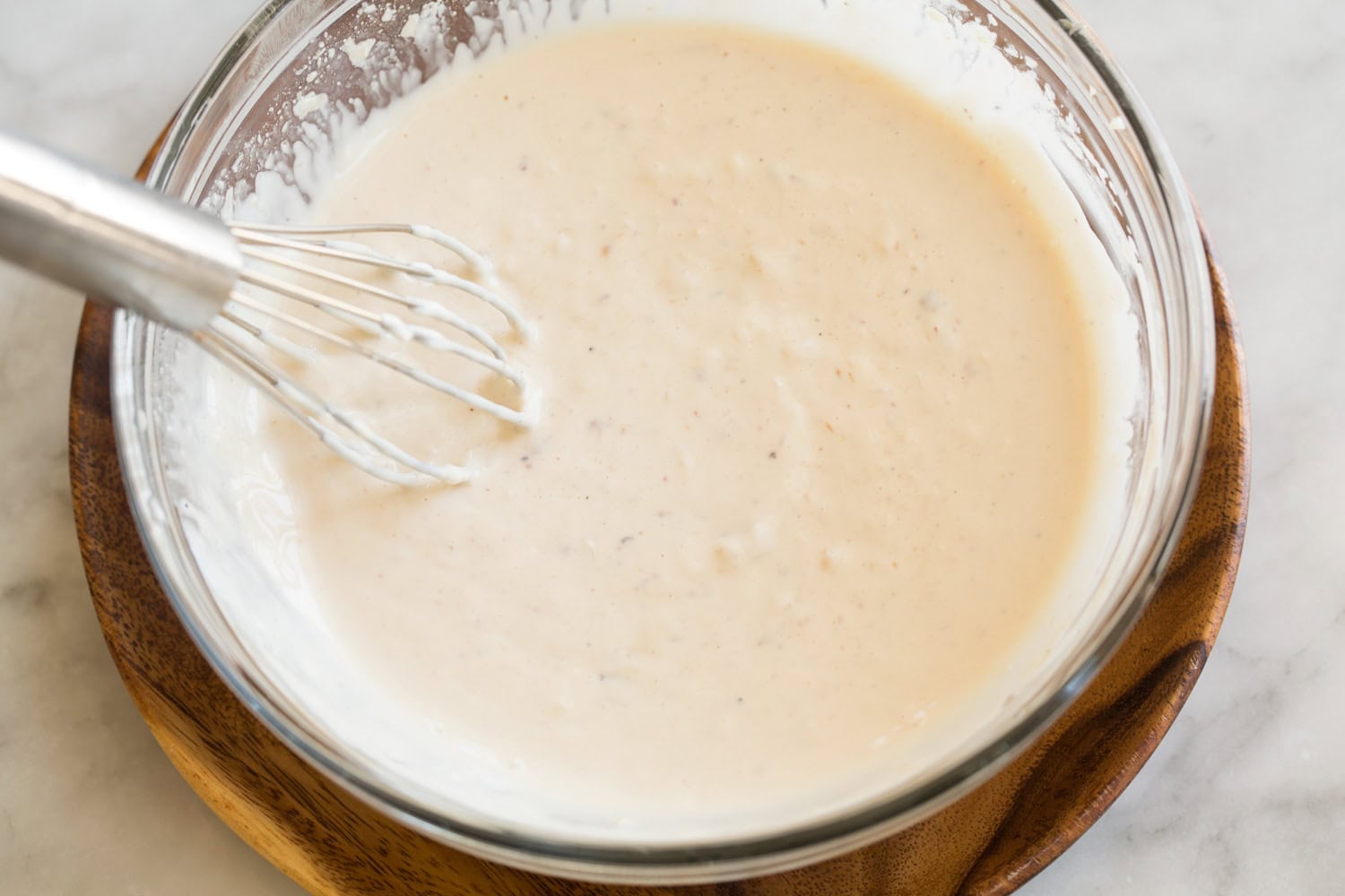 Chicken caesar salad dressing shown after mixing ingredients.