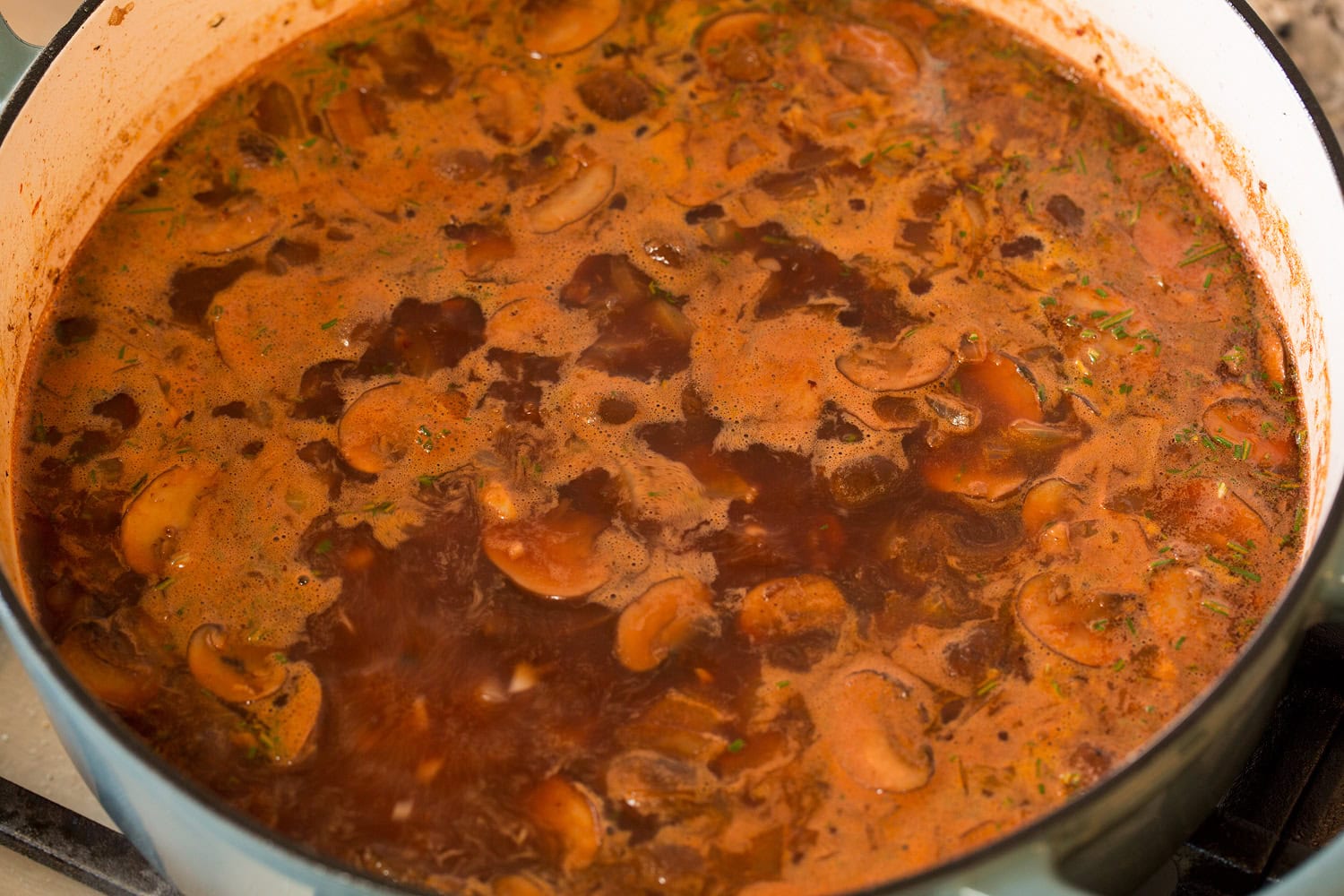 Simmering coq au vin stew.