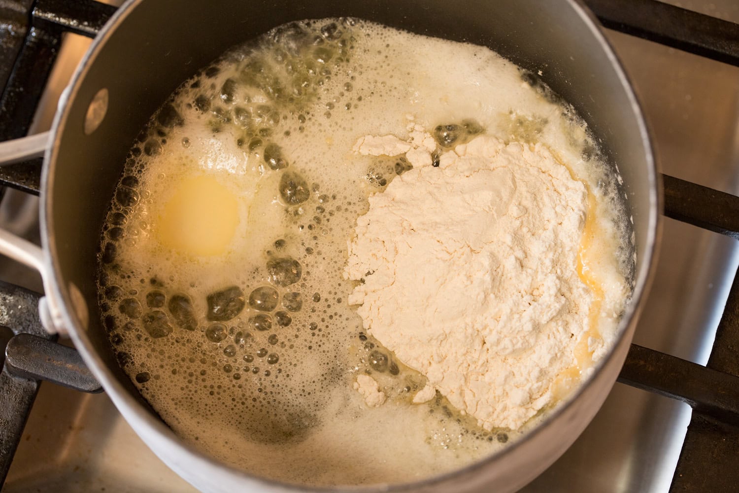 Making roux with flour and melted butter.