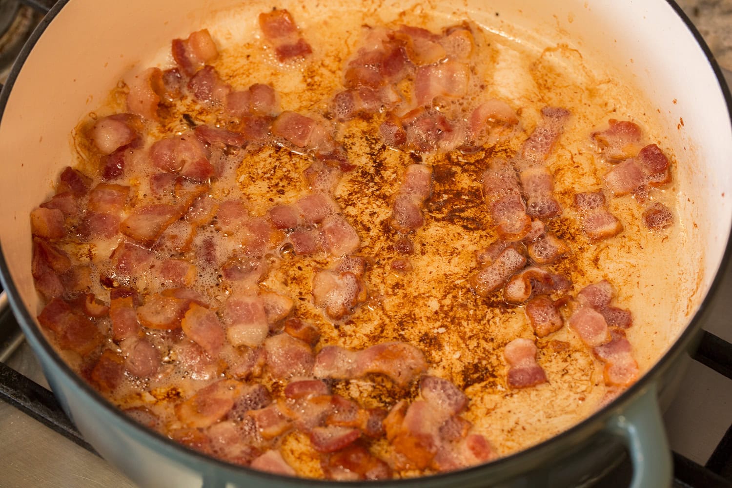 Bacon sautéed in a pot.