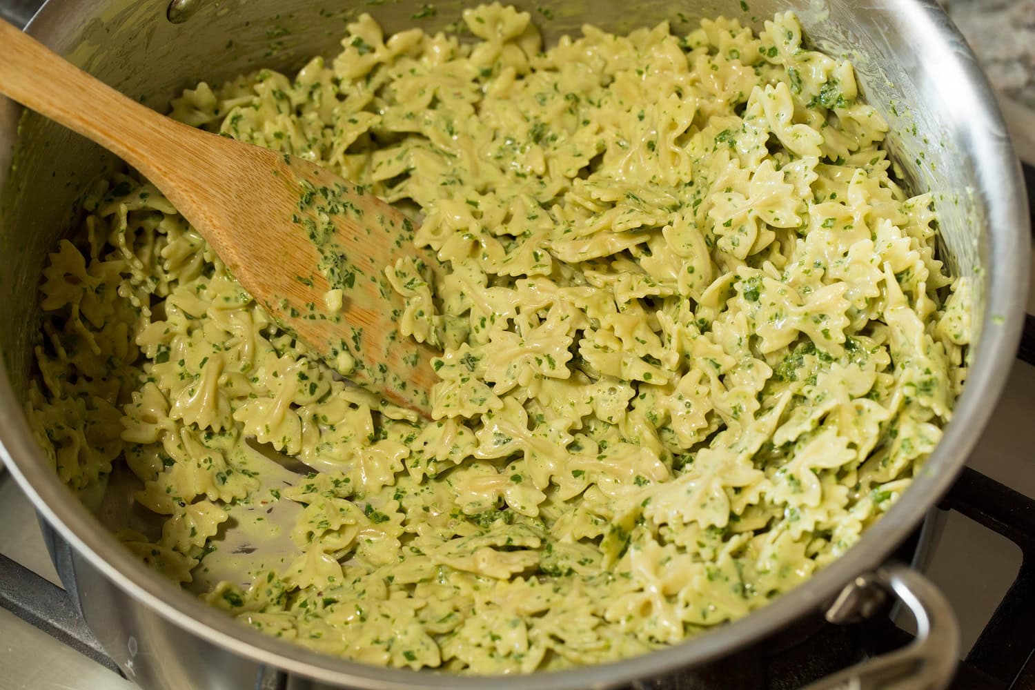 Creamy pesto pasta tossed together and completed.