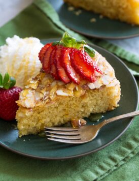 Honey cake shown with variation of serving with strawberries and ice cream.