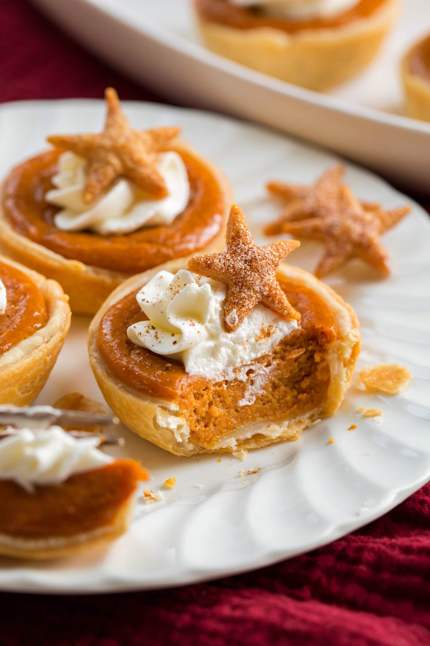 Mini pumpkin pie cut into with a fork showing interior texture.