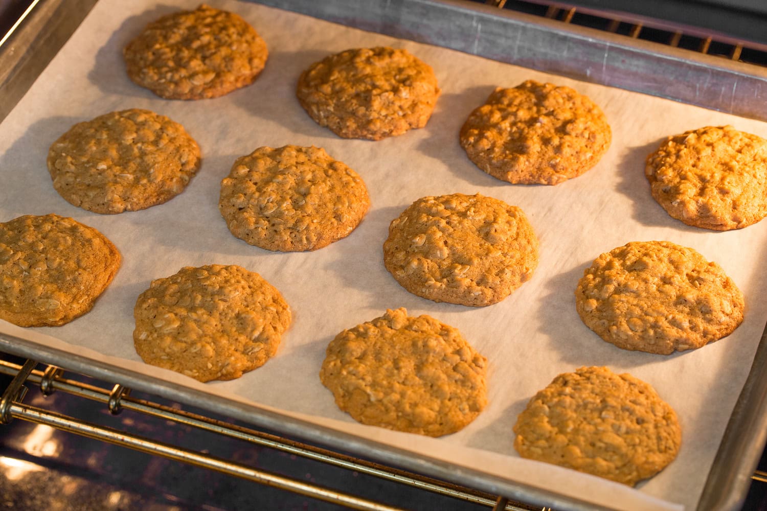 Oatmeal cookies shown baking in oven.