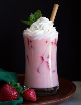 Pink drink with strawberry slices.