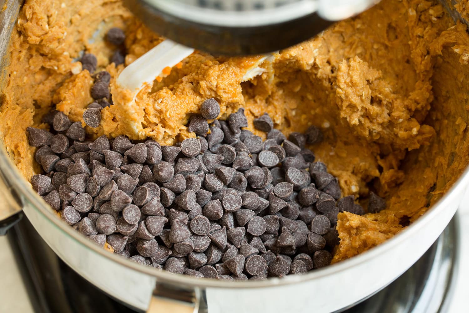 Chocolate chips added to stand mixer with dough.