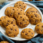 Pumpkin oatmeal cookies on a white serving plate.