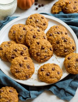 Pumpkin oatmeal cookies on a white serving plate.