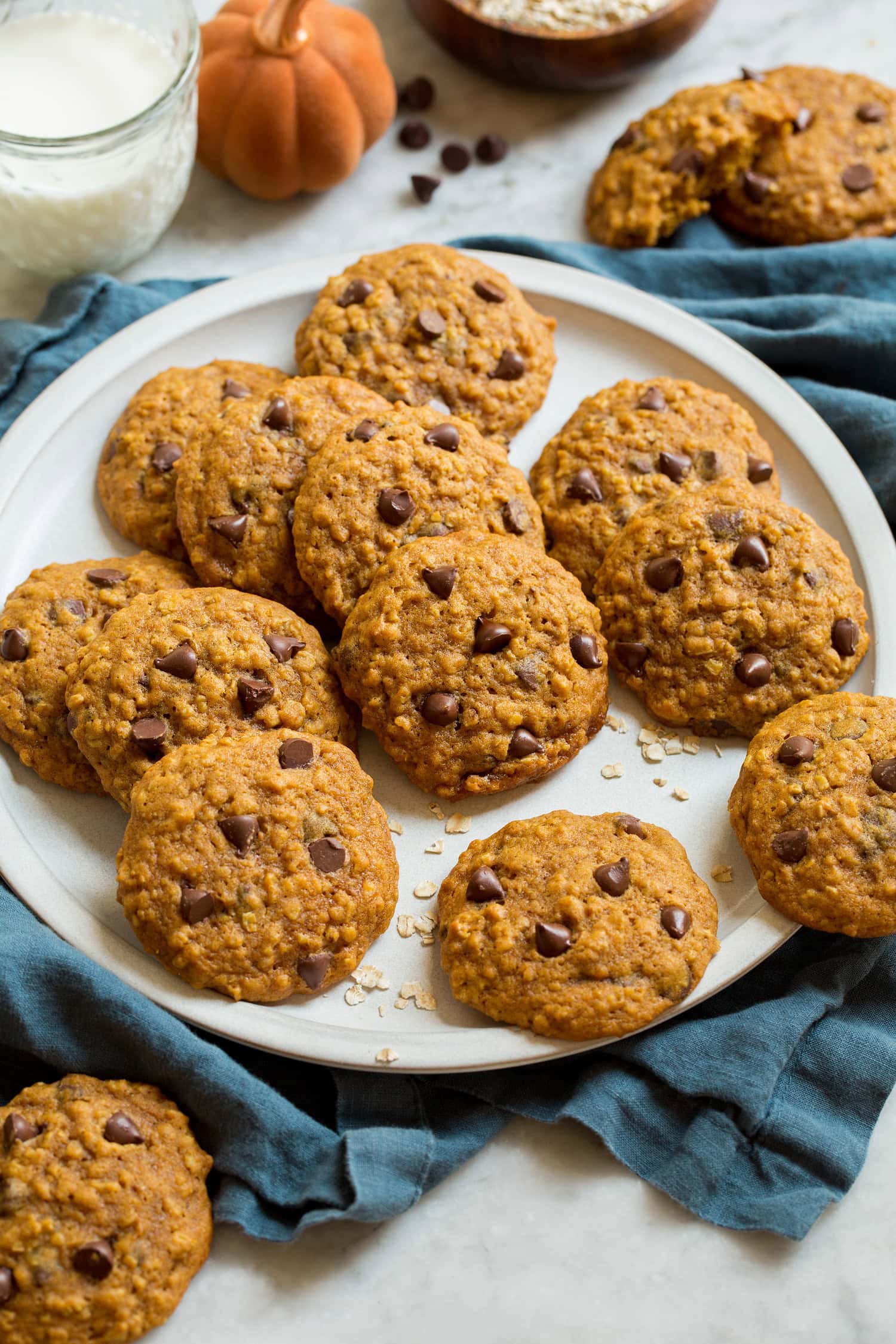 Pumpkin oatmeal cookies on a white serving plate.