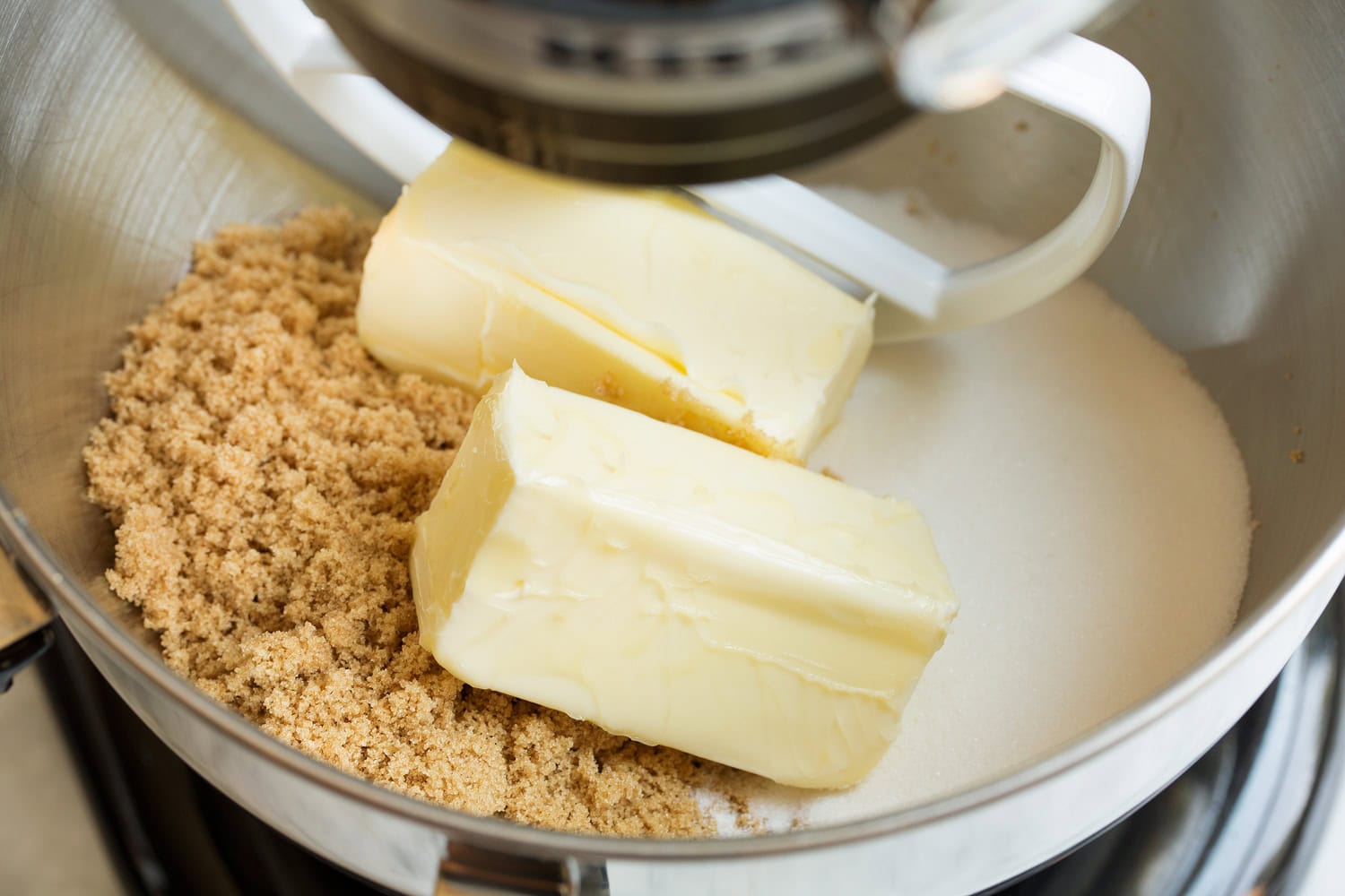 Butter, sugar and brown sugar in a stand mixer before mixing.