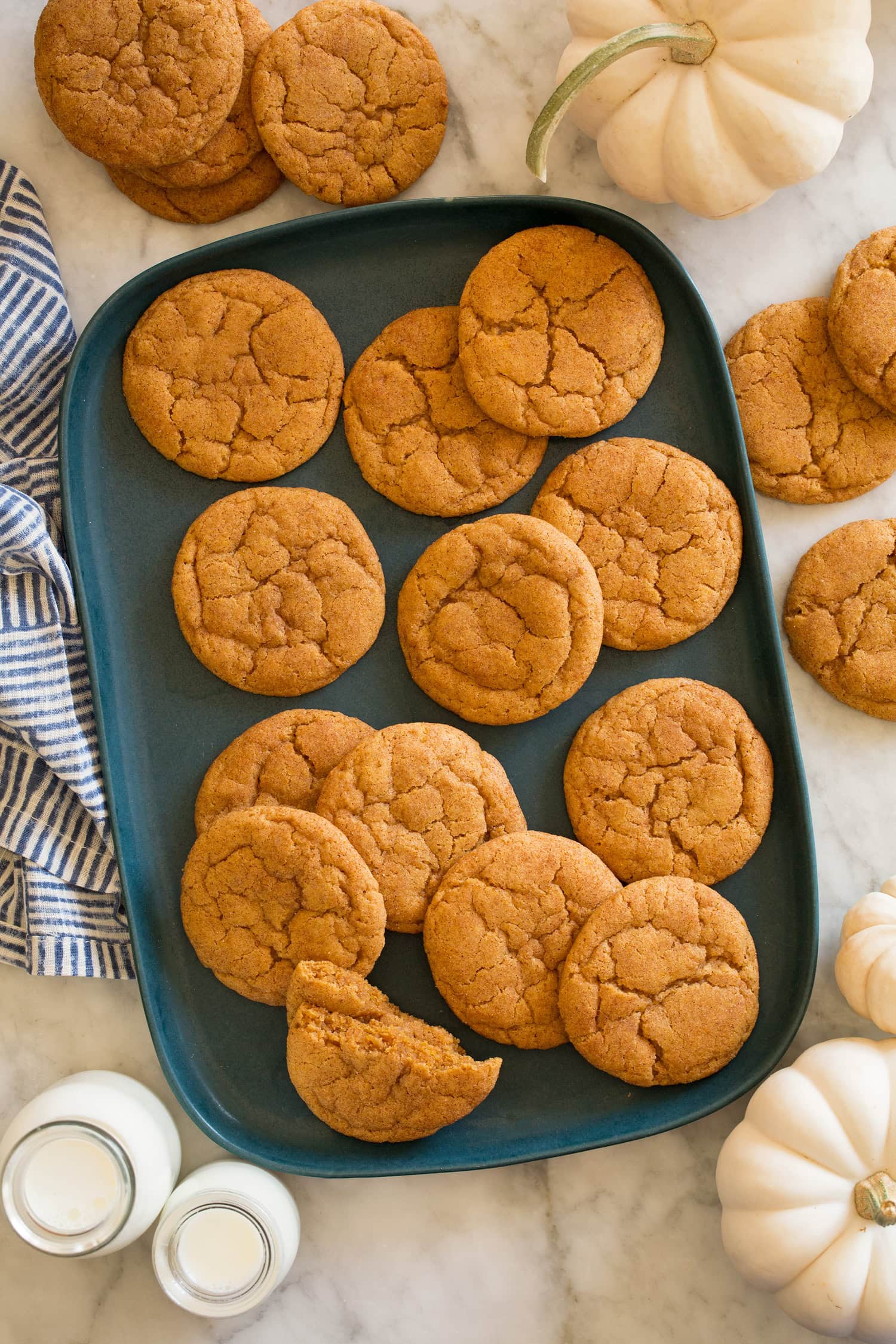 Overhead photo of pumpkin snickerdoodles on a blue rectangular platter.