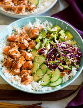 Salmon rice bowl with teriyaki style salmon, cucumber, cabbage, avocado and sriracha mayo.