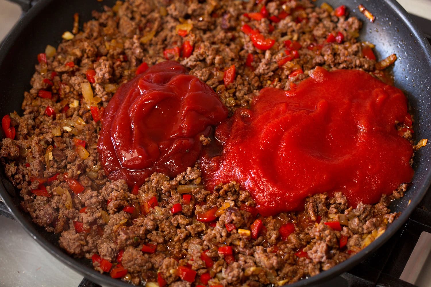 Tomato sauce and ketchup added to beef mixture.