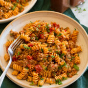 Serving of taco pasta in a pasta bowl with a fork.