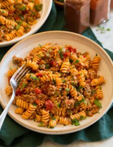 Serving of taco pasta in a pasta bowl with a fork.