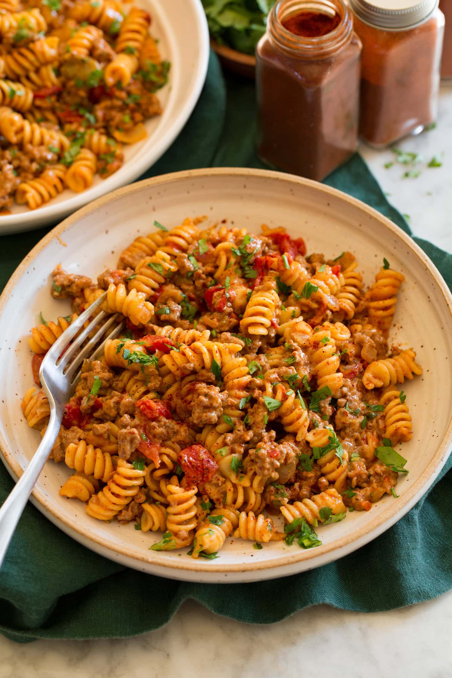 Serving of taco pasta in a pasta bowl with a fork.