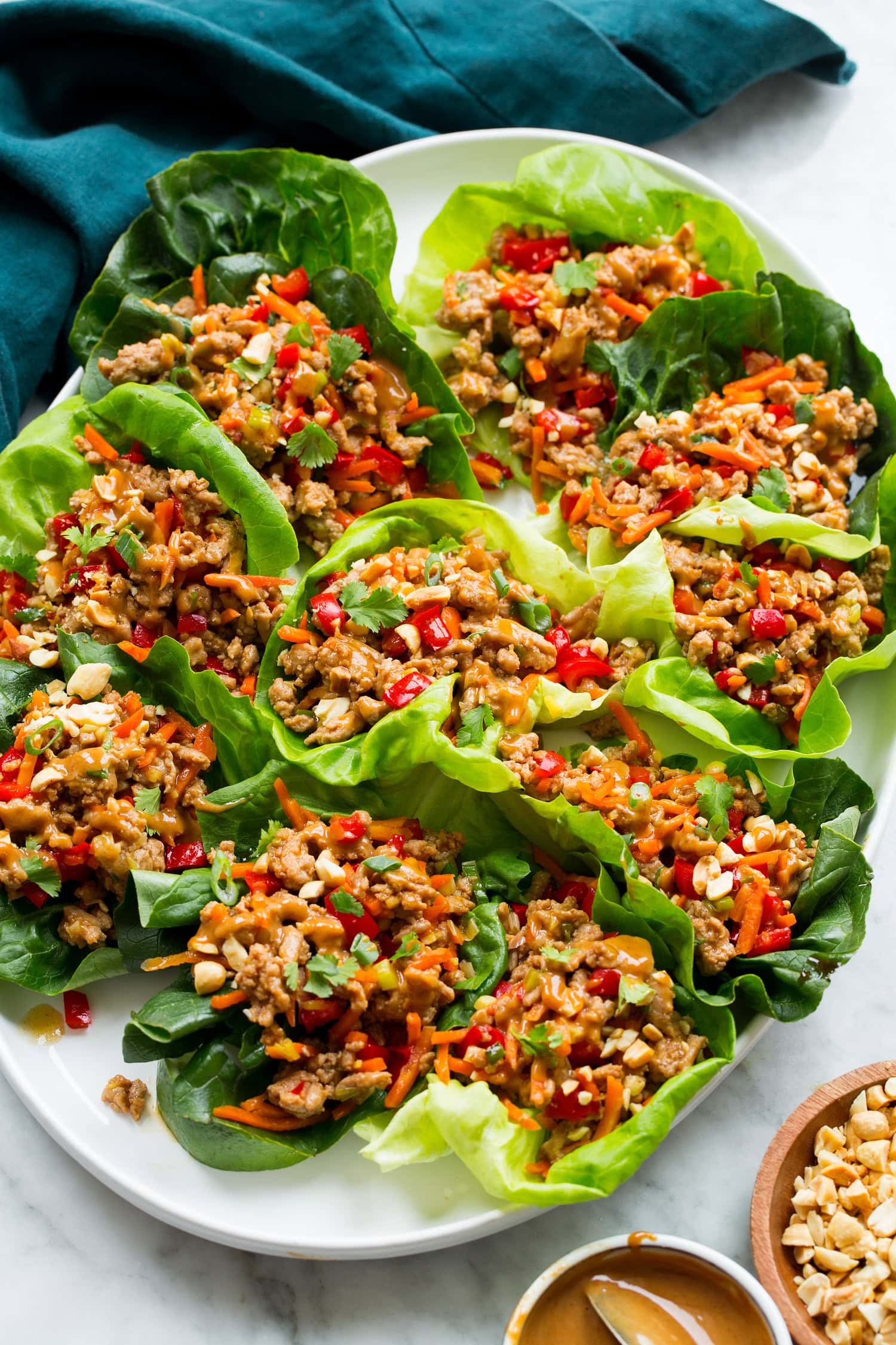 Thai chicken lettuce shown assembled close together on a white oval platter.